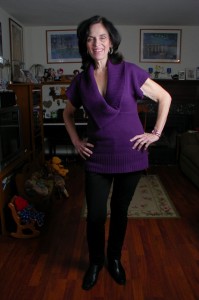 Short sleeve purple sweater with black fitted pants 